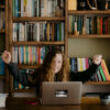Happy girl behind computer: Annie Spratt